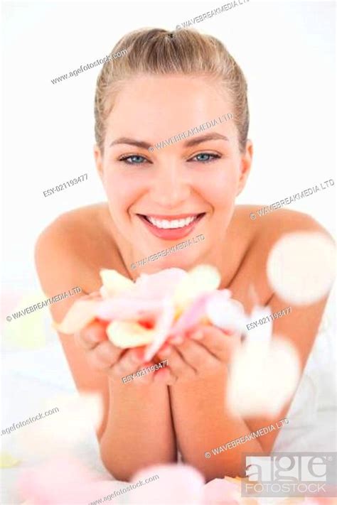 Pretty Blonde Lying On Massage Table Holding Petals Stock Photo