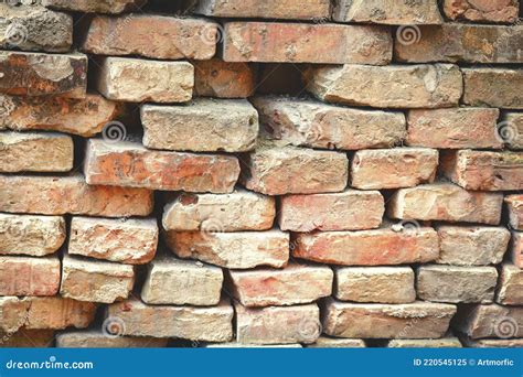 Old Uneven Brick Wall With Sticking Out Bricks And Holes Stock Image