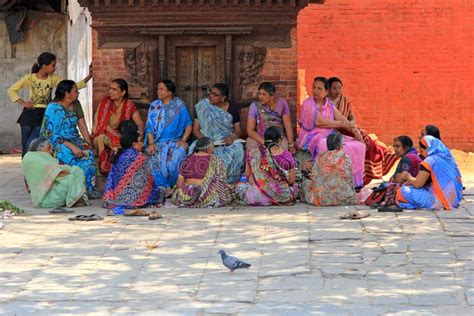 Nepalese Women In Their Traditional Sari Dress Sitting In Front Of