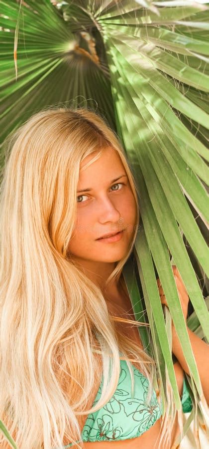 Woman With Blond Hair Wearing Bikini Posing Near Palm Tree Beach