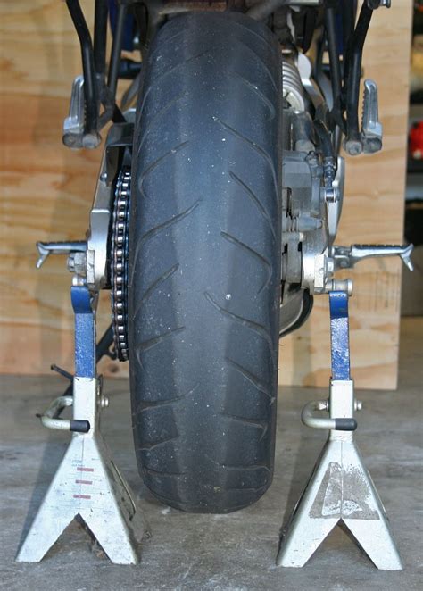 Replace tires when the cords show, they bulge, or you have cuts visible on the inside. How to change your own motorcycle tires - RevZilla