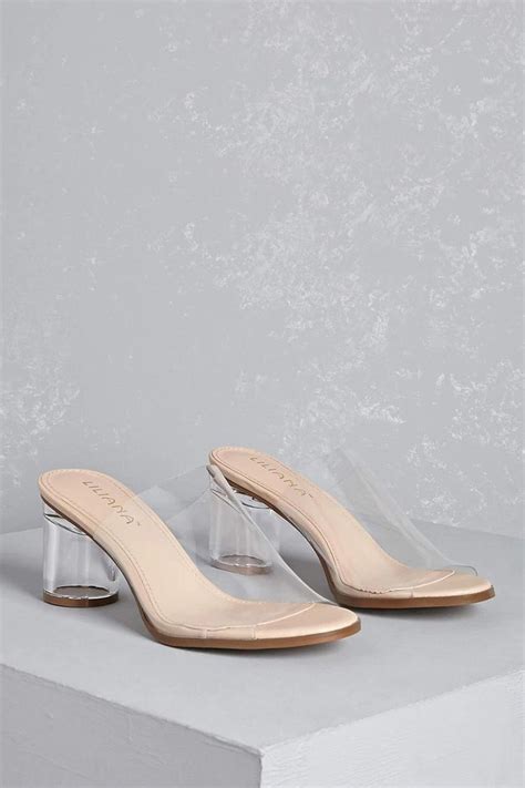 A Pair Of Clear Vinyl Mule Slides Featuring A Lucite Block Heel And Open Toe Design This Is