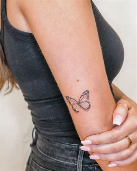 Fine Line Butterfly Tattoo On The Tricep