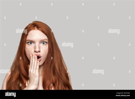 I Dont Believe Studio Shot Of Cute Redhead Surprised Girl Making