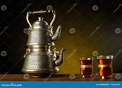 A Still Life With Turkish Double Teapot Authentic Glasses And Sweets