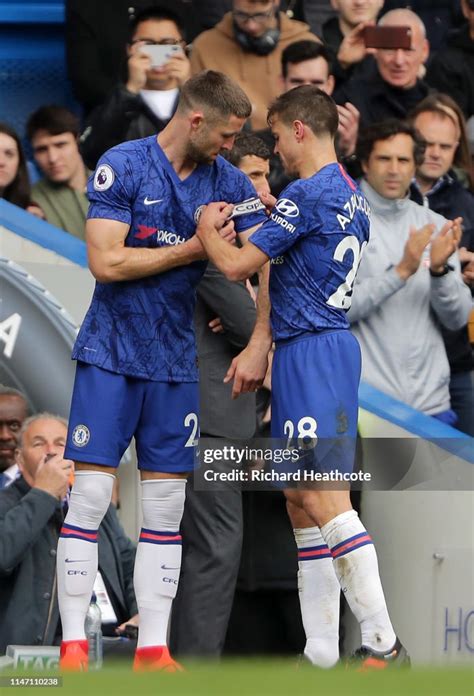 Cesar Azpilicueta Of Chelsea Passes The Captains Armband To Gary