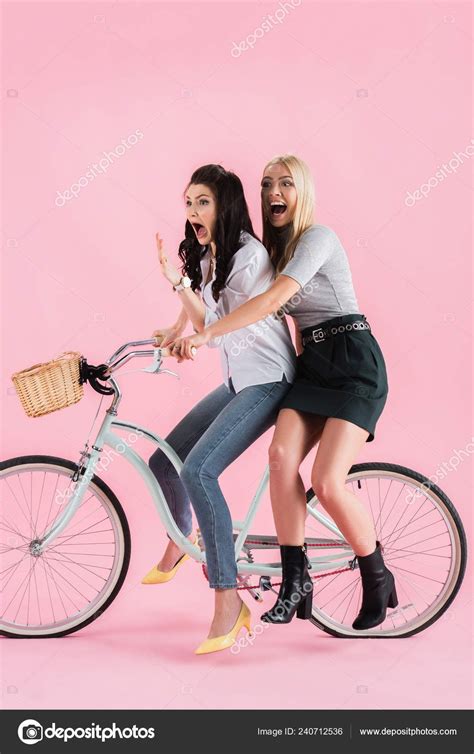 shocked girls screaming while riding bike pink background in 2022 riding bike pink background