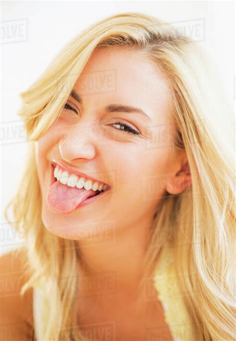Portrait Of Teenage Girl Sticking Tongue Out Stock Photo