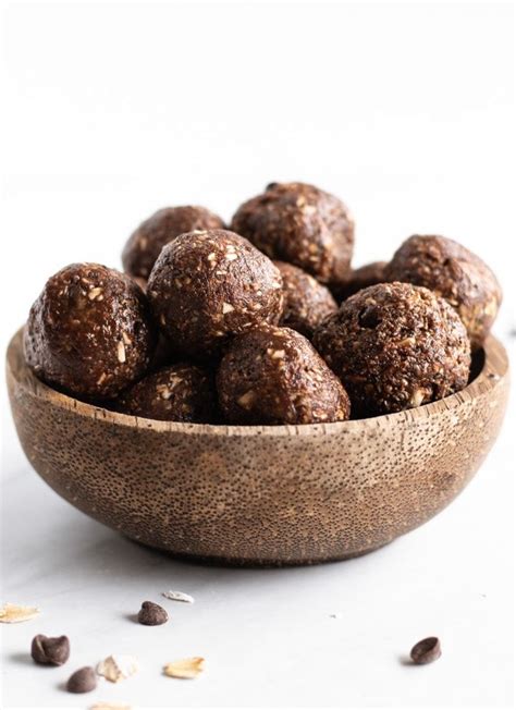 Add some chopped walnuts and a few chocolate chips on top and you have a decadently delicious treat! A coconut shell bowl filled with little energy balls aka ...