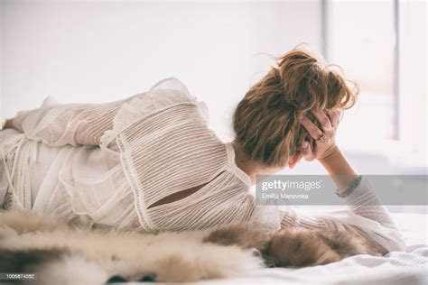 Beautiful Woman Lying In Bed In White Dress Photo Getty Images