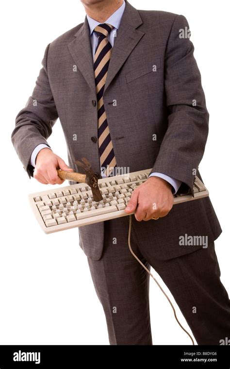 Angry Businessman Destroying A Keyboard With A Hammer Isolated On White