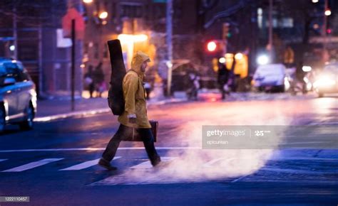 Man Walking Across An Empty Street In New York City New York Street