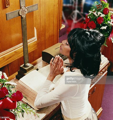 Young Woman Kneeling At An Altar In Church And Praying Photo Getty Images