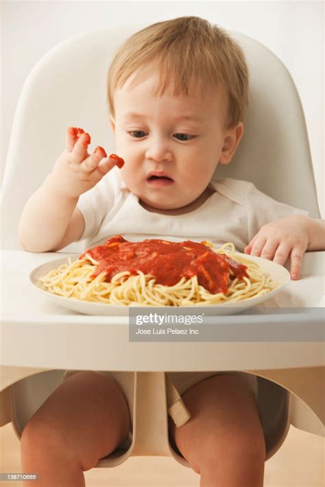 Mixed Race Baby Boy Eating Spaghetti High Res Stock Photo Getty Images