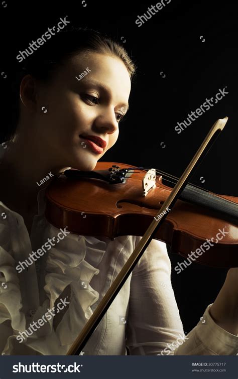 Portrait Of A Pretty Young Woman Playing The Violin Stock Photo