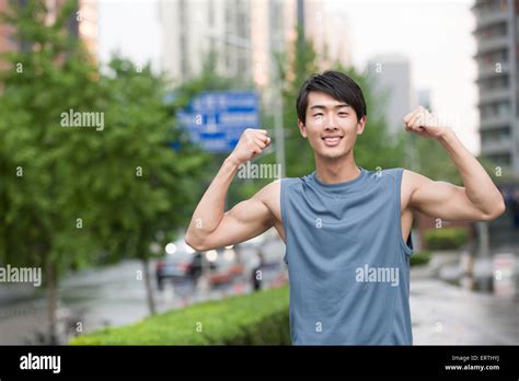 Young Man Flexing His Muscles Stock Photo Alamy