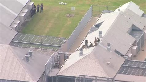 brisbane borallon correctional centre sent into lockdown after prisoners scale roof daily