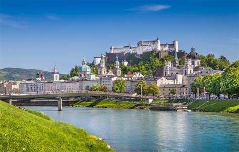 Salzburg is located at the foot of the alps on the border with germany. Salzburg skyline with Festung Hohensalzburg and Salzach ...