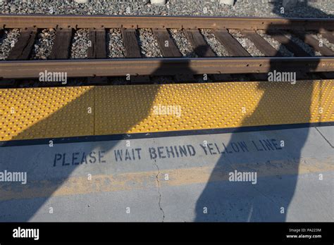 Yellow Line Marked Please Wait Behind Yellow Line On A Metrolink