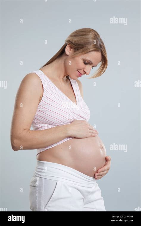 Pregnant Mid Adult Woman Watching Her Belly Stock Photo Alamy