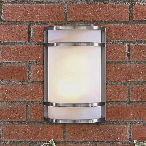 A Wall Mounted Light On The Side Of A Red Brick Building With A White