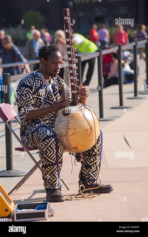 Man Playing Kora Or Cora An African Stringed Musical Instrument At Greenwich London In