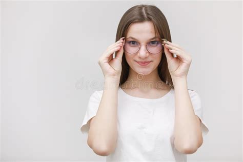 Focused Frowning Office Girl Staring At Camera Through Eyeglasses On