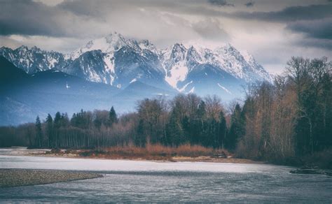At The Riverbend At The Cascade Mountains Rise Over The Skykomish River