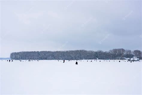 Premium Photo Fishermen Catch Fish On A Frozen Lake On Winter Fishing