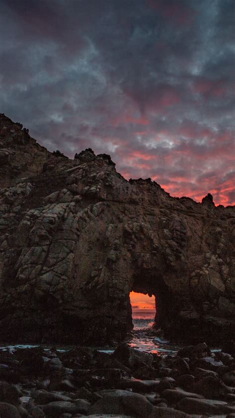 Download Wallpaper 720x1280 Keyhole Arch Sunset Cliff Coast Nature