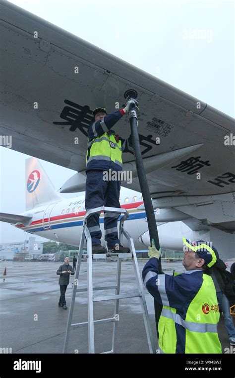 A Chinese Ground Crew Member Fuels An Airbus A320 Jet Plane Of China