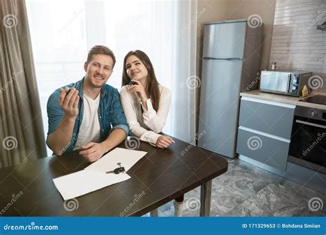 Lovely Satisfied Couple Man And Woman Sitting In Their New Cosy Apartment After Successful Lease