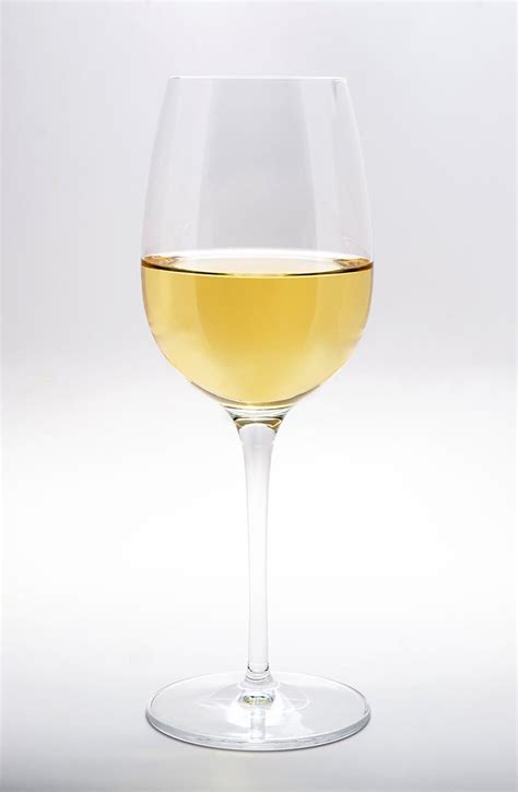 A Glass Of White Wine Against White Background Stockfreedom Premium