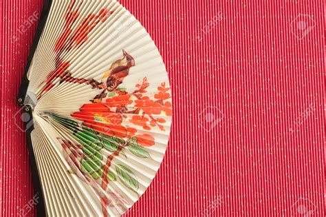 Chinese Paper Fan Craft A Chinese Hand Fan Isolated On A Red Background