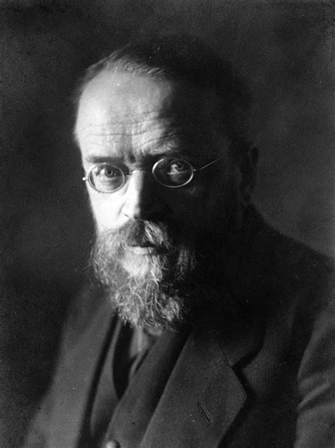 An Old Black And White Photo Of A Man With Glasses