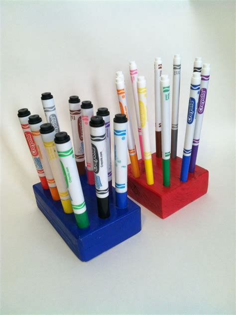 There Are Many Pens In The Holder On The Table And One Is Multicolored
