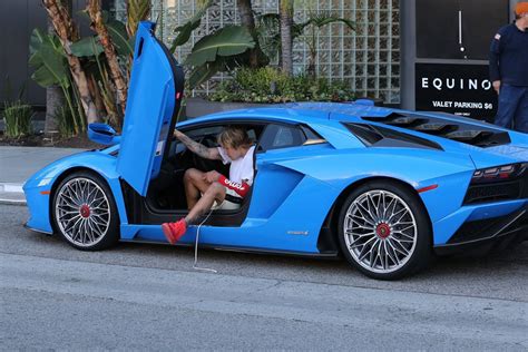 justin bieber shows off his lamborghini aventador and kanye west s 9 000 nike air yeezy
