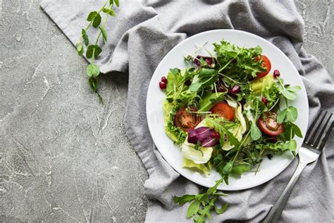 Fresh Green Mixed Salad Bowl With Tomatoes And Microgreens Stock Photo