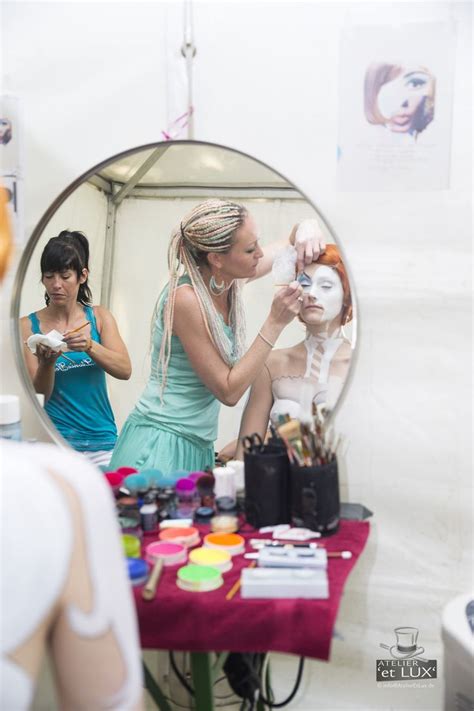 A Woman Standing In Front Of A Mirror With Makeup On Her Face And Other