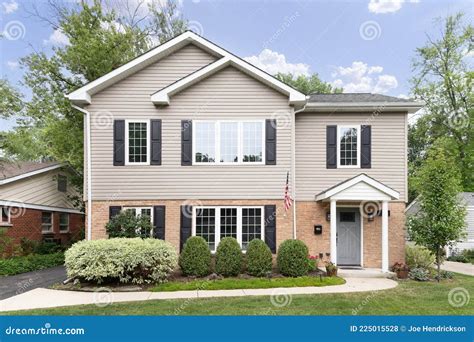 A Two Story Suburban Home With Vinyl And Brick Siding Editorial Stock