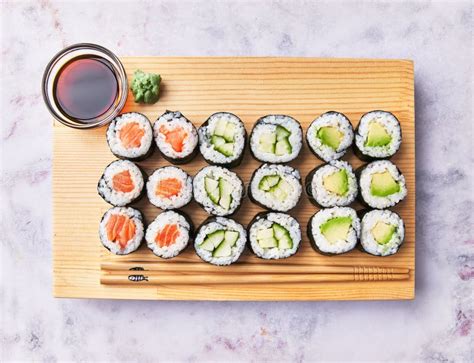 Wooden Board With Avocado Salmon And Cucumber Sushi Makis On A Marble