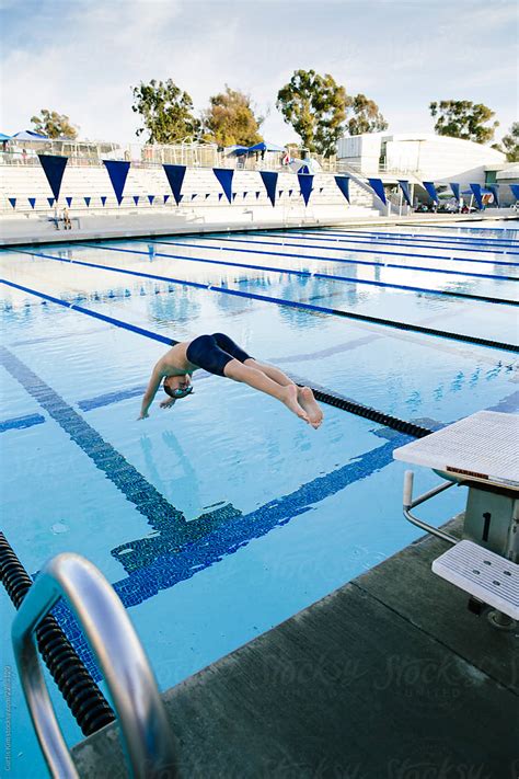 athlete diving into olympic pool by stocksy contributor curtis kim stocksy