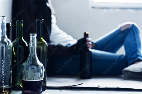 Closeup Empty Glass Bottles On Background Homeless Drunk Woman Is Sitting On Cardboard On Floor
