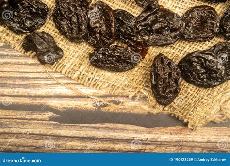 Dried Prunes In Bulk On Burlap With A Rough Texture Close Up Stock