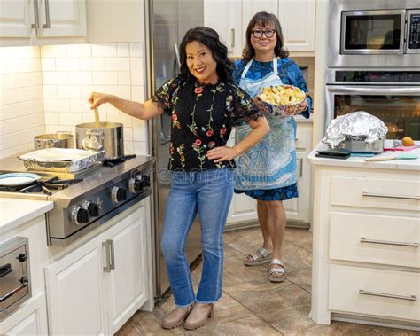 Fifty Seven And Sixty Four Year Old Korean Women Cooking Up Thanksgiving Dinner In Edmond