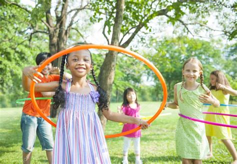 Children Playing With Hula Hoops In The Park — Stock Photo © Rawpixel