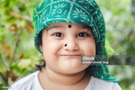 Cute Indian Baby Girl With Traditional Indian Dress With Bindi On Her