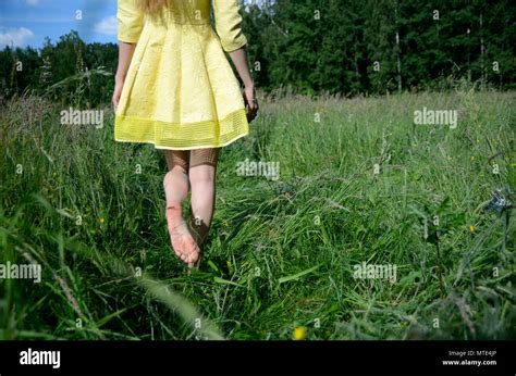 Female Walks On The Grass With Barefoot Young Woman Enjoys Outdoor