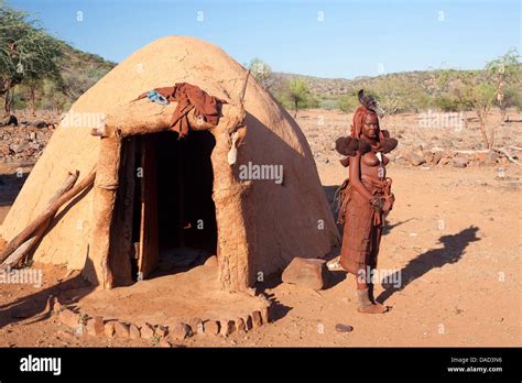 Himba Woman Outside Her Traditional Dwelling In A Himba Village In The