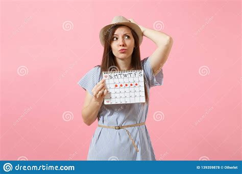 Portrait Of Shocked Woman In Blue Dress Hat Holding Periods Calendar
